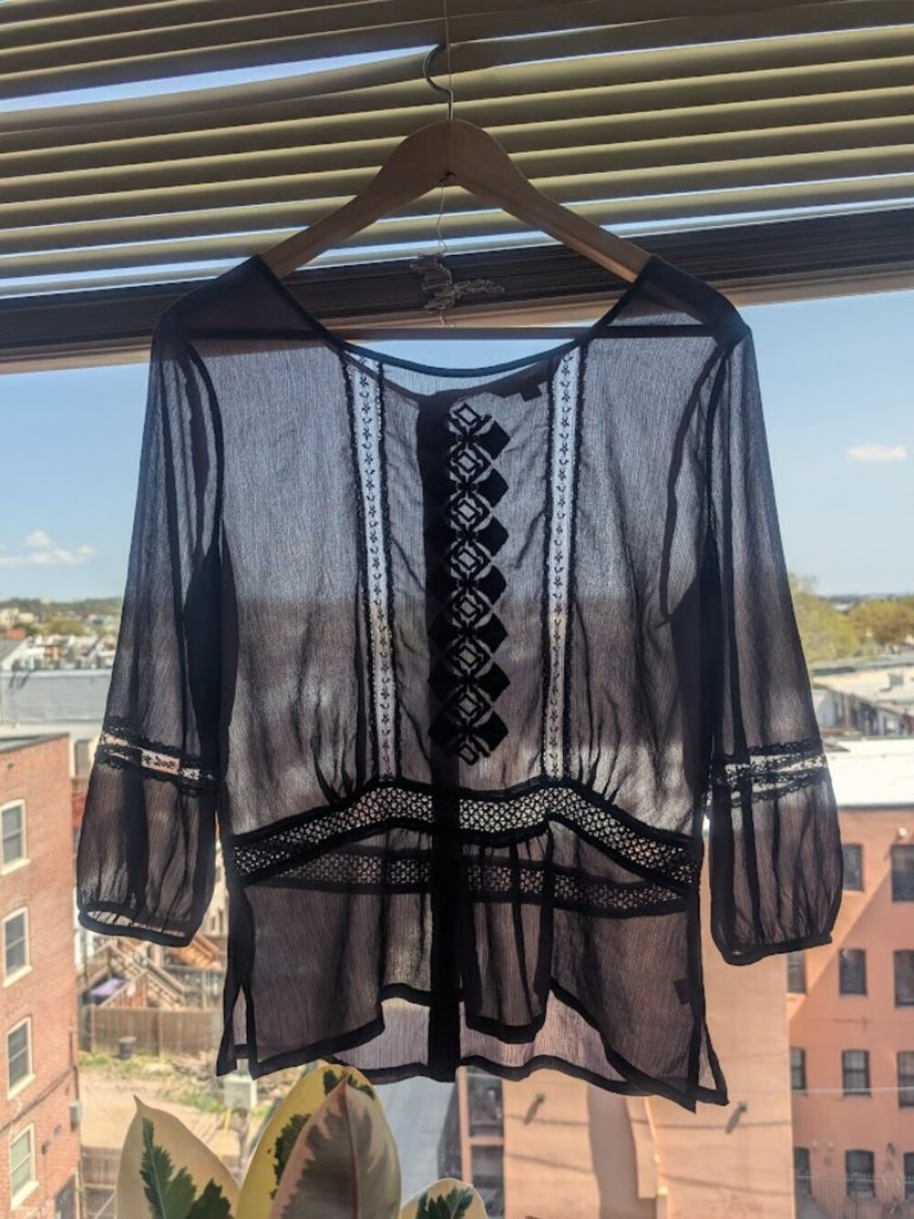 Sheer purple blouse with embroidery detailing.